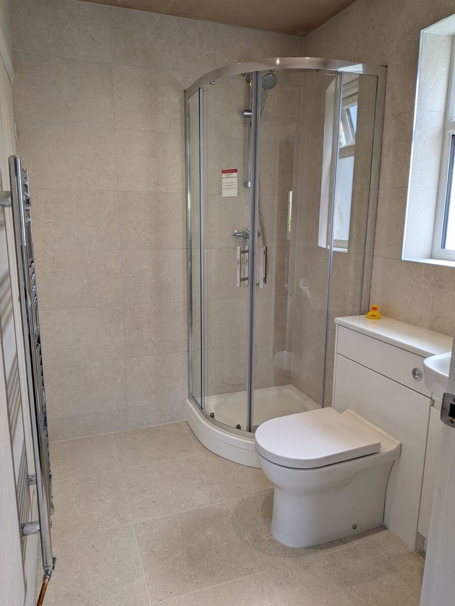 Quadrant shower enclosure in beige stone-effect tiles